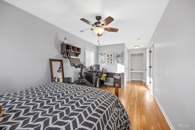 bedroom with ceiling fan and hardwood / wood-style floors