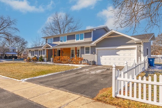 view of front facade featuring a porch, a front lawn, and a garage