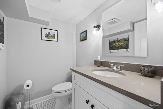 bathroom with toilet, tile patterned flooring, and vanity