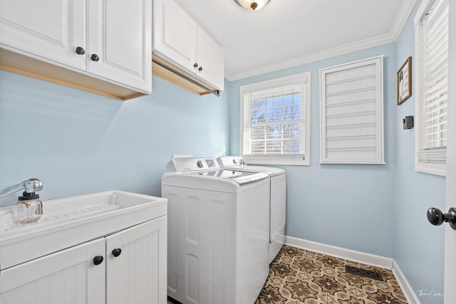 laundry area with separate washer and dryer, cabinets, crown molding, and sink