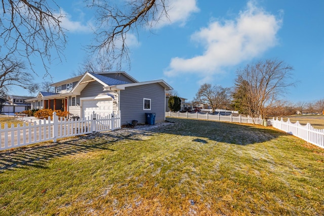 view of home's exterior featuring a yard and a garage