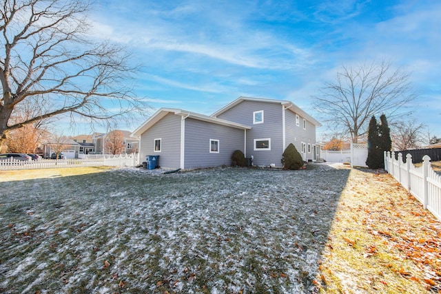 rear view of property featuring a yard