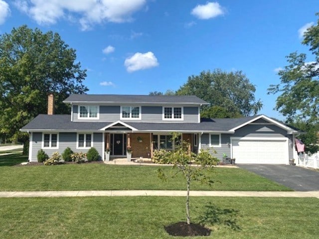 front facade featuring a front yard and a garage