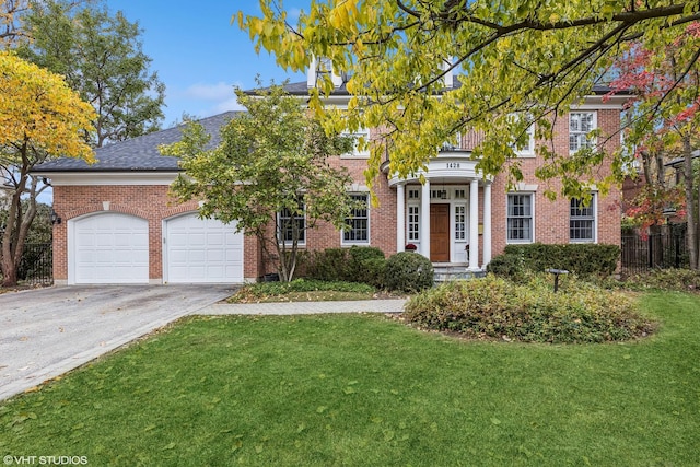 view of front of property featuring a garage and a front lawn