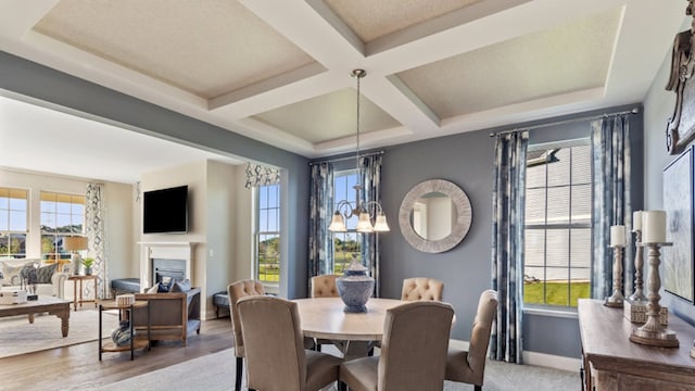 dining space with beamed ceiling, hardwood / wood-style floors, coffered ceiling, and a notable chandelier