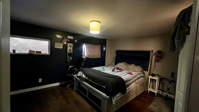 bedroom with dark hardwood / wood-style floors