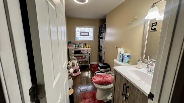 bathroom with vanity, hardwood / wood-style flooring, and toilet