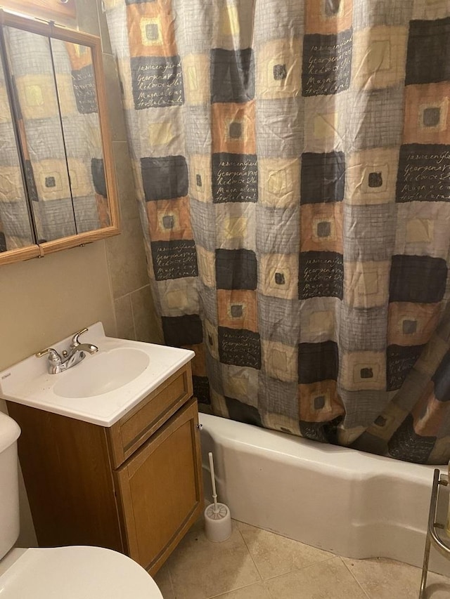 bathroom featuring tile patterned flooring, vanity, and shower / tub combo