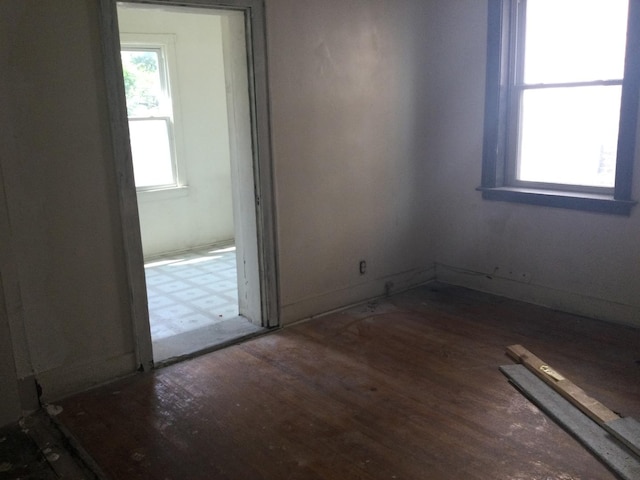 empty room with dark hardwood / wood-style floors