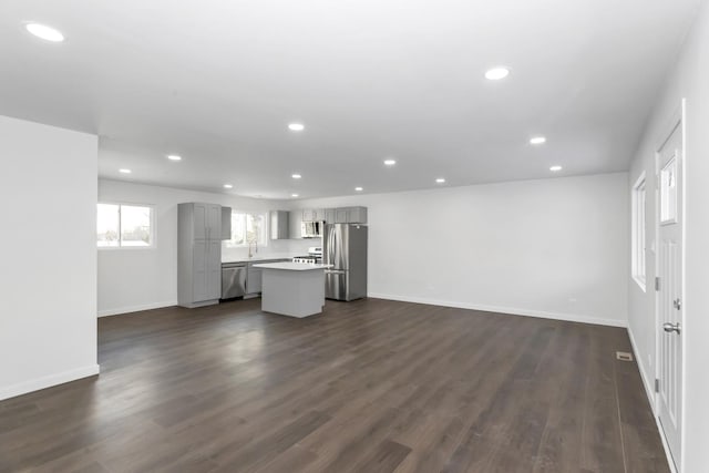 unfurnished living room featuring dark hardwood / wood-style floors