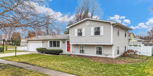 split level home with a front yard and a garage