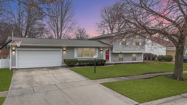 split level home with a yard and a garage