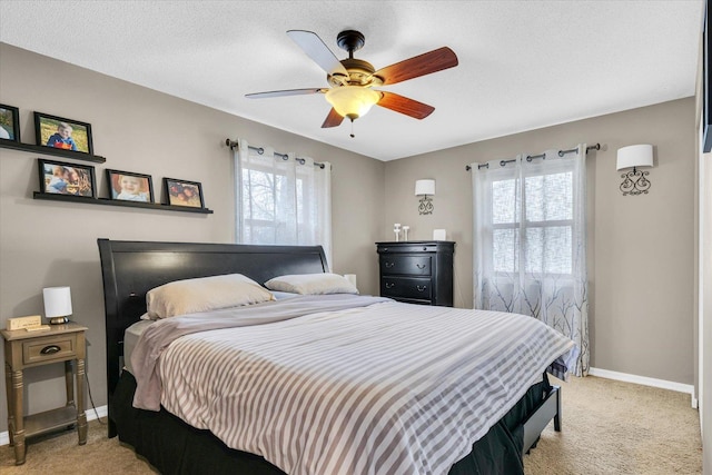 carpeted bedroom featuring a textured ceiling and ceiling fan