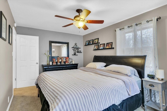 bedroom with ceiling fan and light carpet