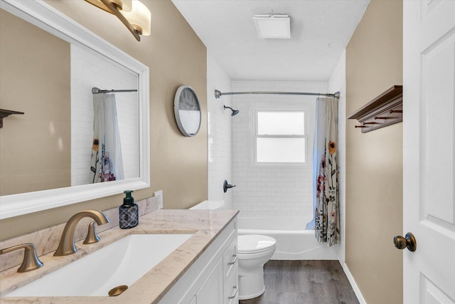 full bathroom featuring hardwood / wood-style floors, shower / bath combination with curtain, a textured ceiling, toilet, and vanity