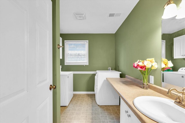 bathroom featuring washer and clothes dryer and vanity