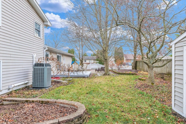 view of yard with central AC unit and a wooden deck