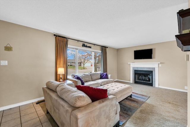 living room featuring light tile patterned floors, a textured ceiling, and a tiled fireplace