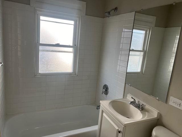 full bathroom featuring vanity, toilet, and tiled shower / bath