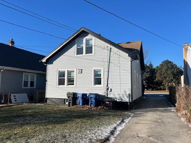 rear view of property featuring a yard