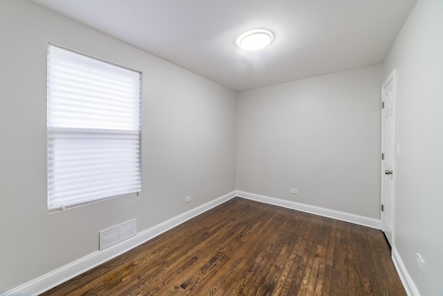 spare room featuring dark wood-type flooring