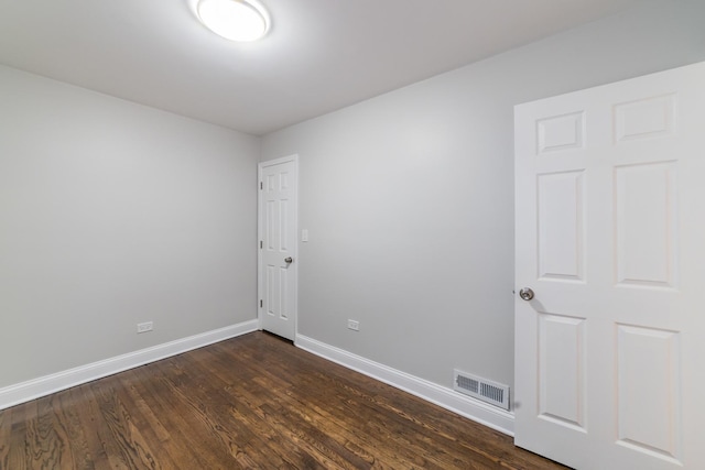 spare room featuring dark hardwood / wood-style floors