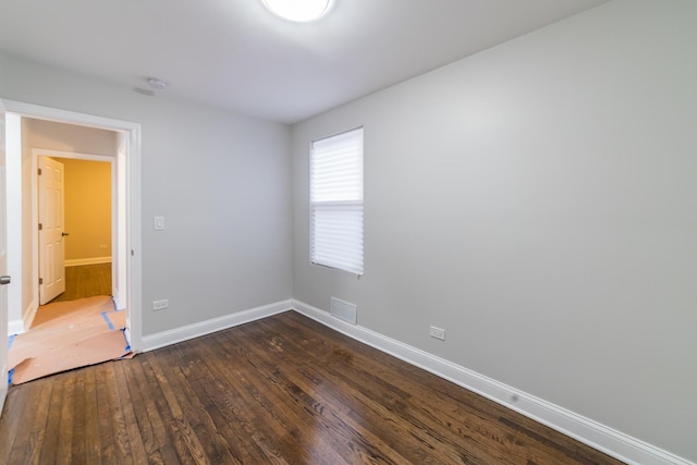 spare room with dark wood-type flooring