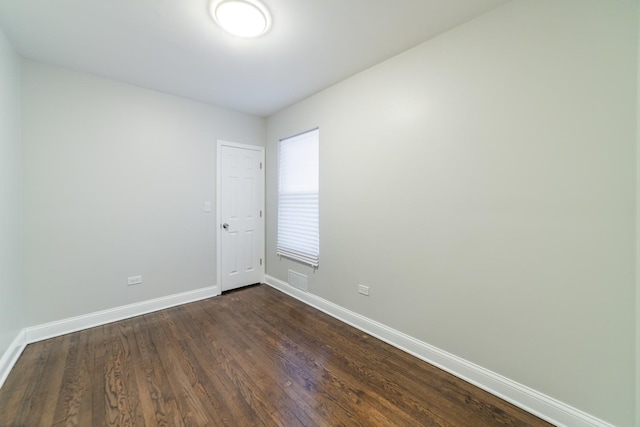 empty room with dark wood-type flooring