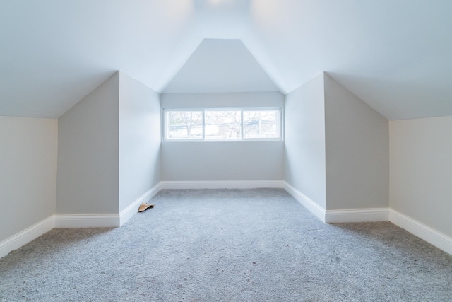 bonus room with lofted ceiling and carpet floors