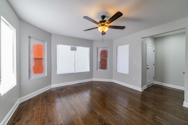 empty room featuring ceiling fan and dark wood-type flooring