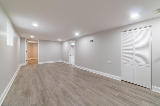 basement with light hardwood / wood-style flooring