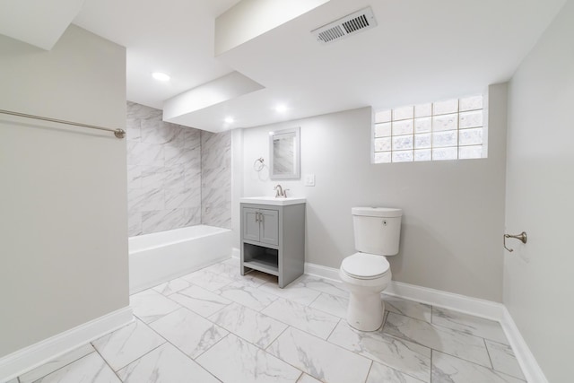 full bathroom with vanity, toilet, and tiled shower / bath