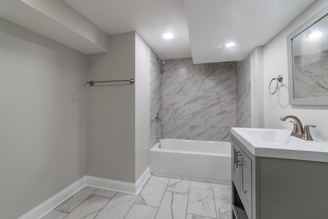 bathroom featuring vanity and tiled shower / bath