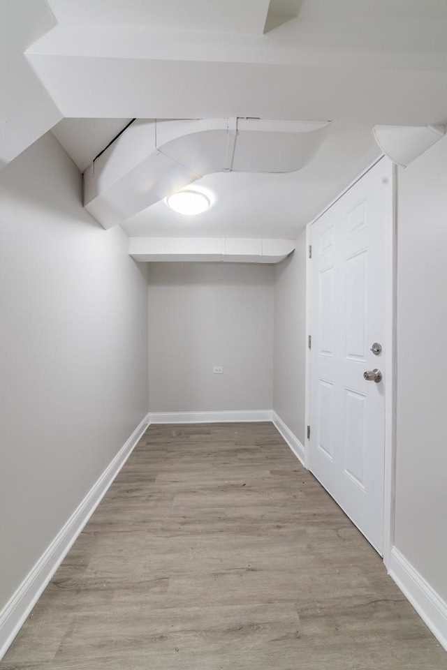 basement with light hardwood / wood-style flooring