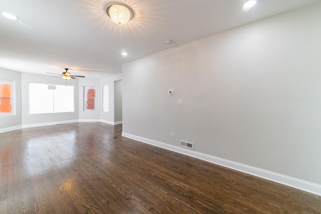 unfurnished room featuring ceiling fan and dark wood-type flooring