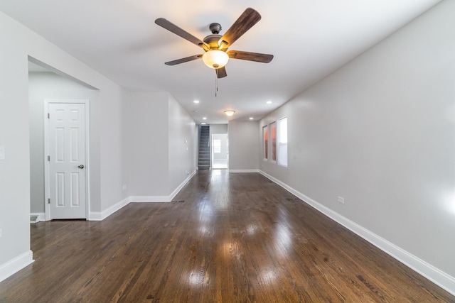 spare room featuring ceiling fan and dark hardwood / wood-style flooring