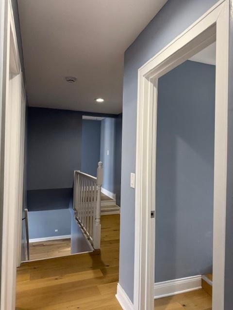 corridor with light hardwood / wood-style floors