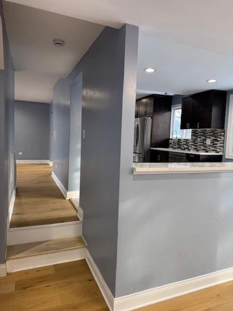 staircase featuring hardwood / wood-style floors and sink