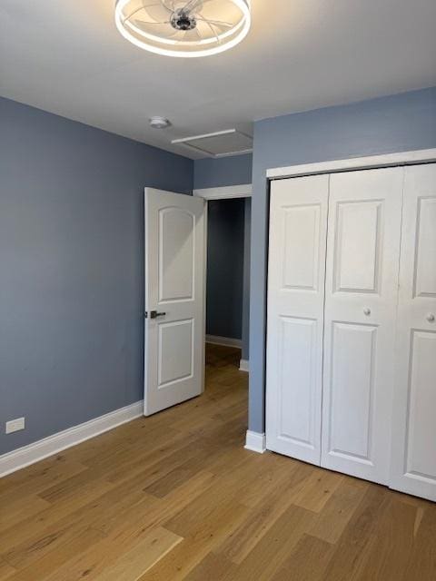 unfurnished bedroom featuring light hardwood / wood-style floors and a closet