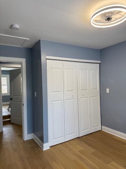 unfurnished bedroom featuring wood-type flooring and a closet