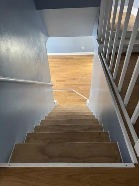 stairs featuring wood-type flooring