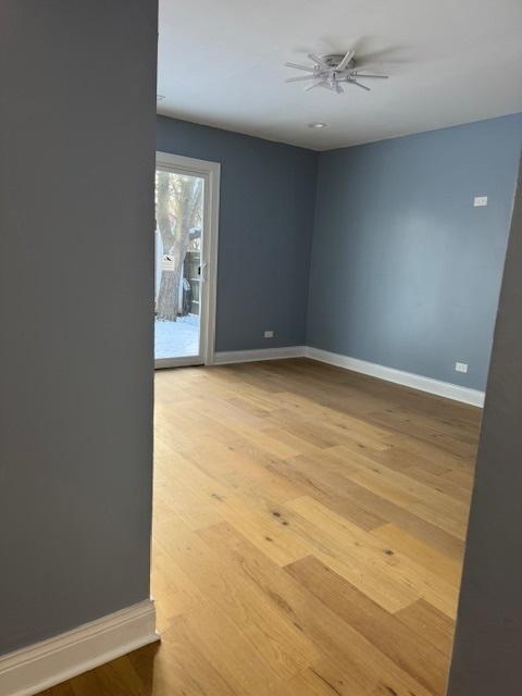 empty room featuring light wood-type flooring and ceiling fan