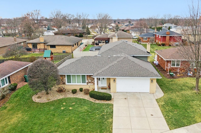 view of front of property with a front yard and a garage