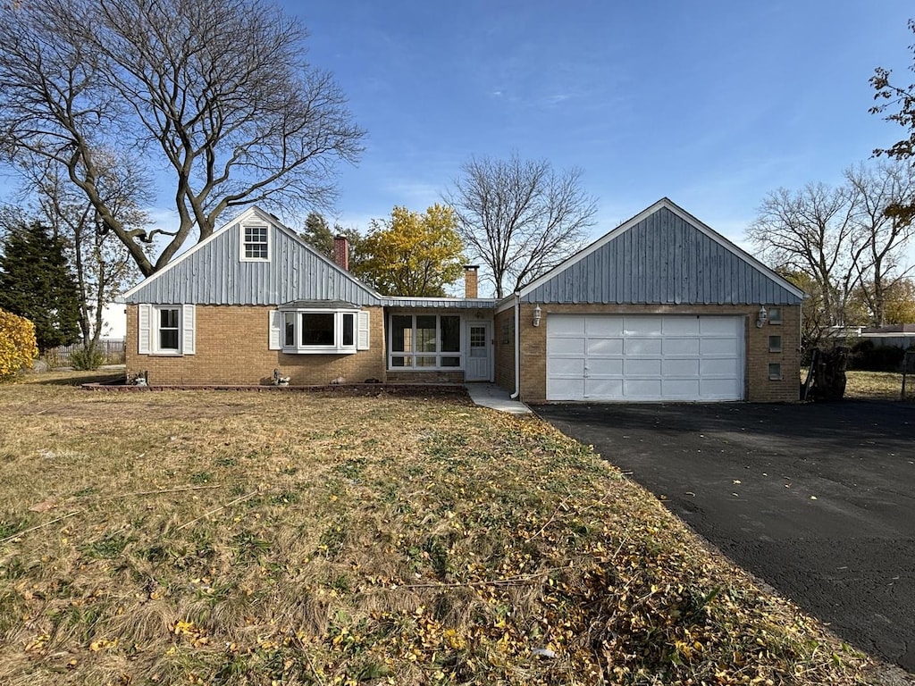 view of front of property with a front lawn and a garage