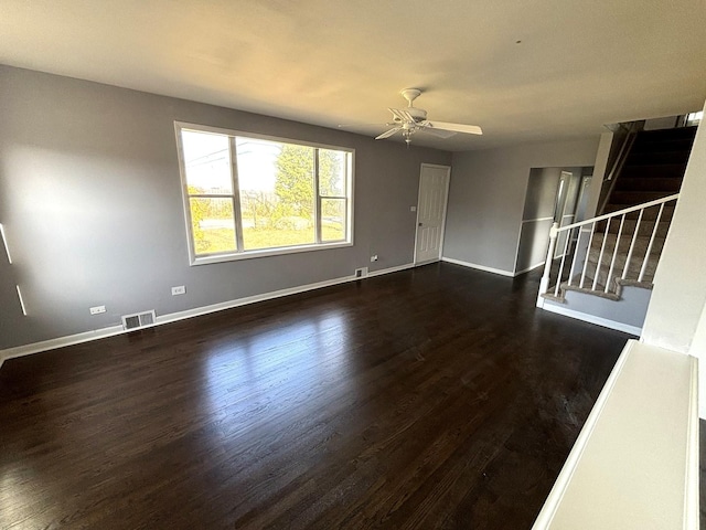 unfurnished living room featuring dark hardwood / wood-style floors and ceiling fan