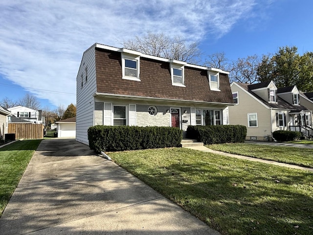 view of front of house with an outdoor structure, a front yard, and a garage