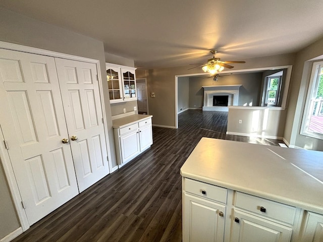 kitchen featuring white cabinets, ceiling fan, and dark wood-type flooring