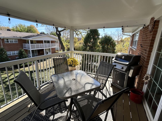 wooden terrace with a grill