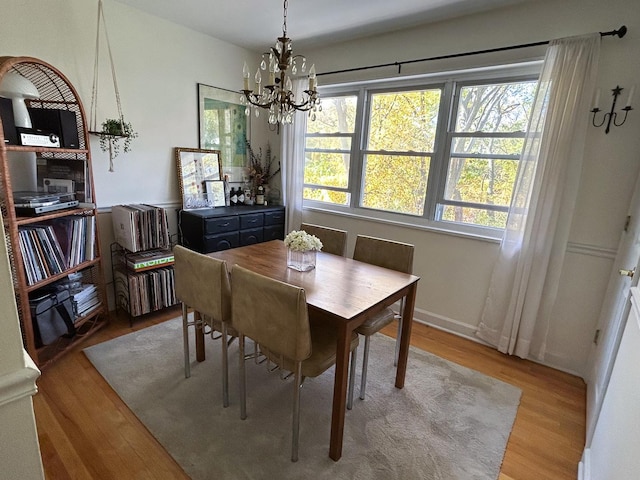 dining area with a notable chandelier and light wood-type flooring