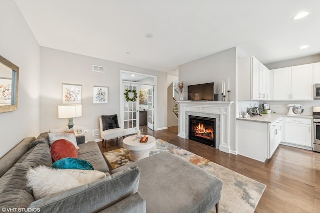 living room with wood-type flooring and a fireplace